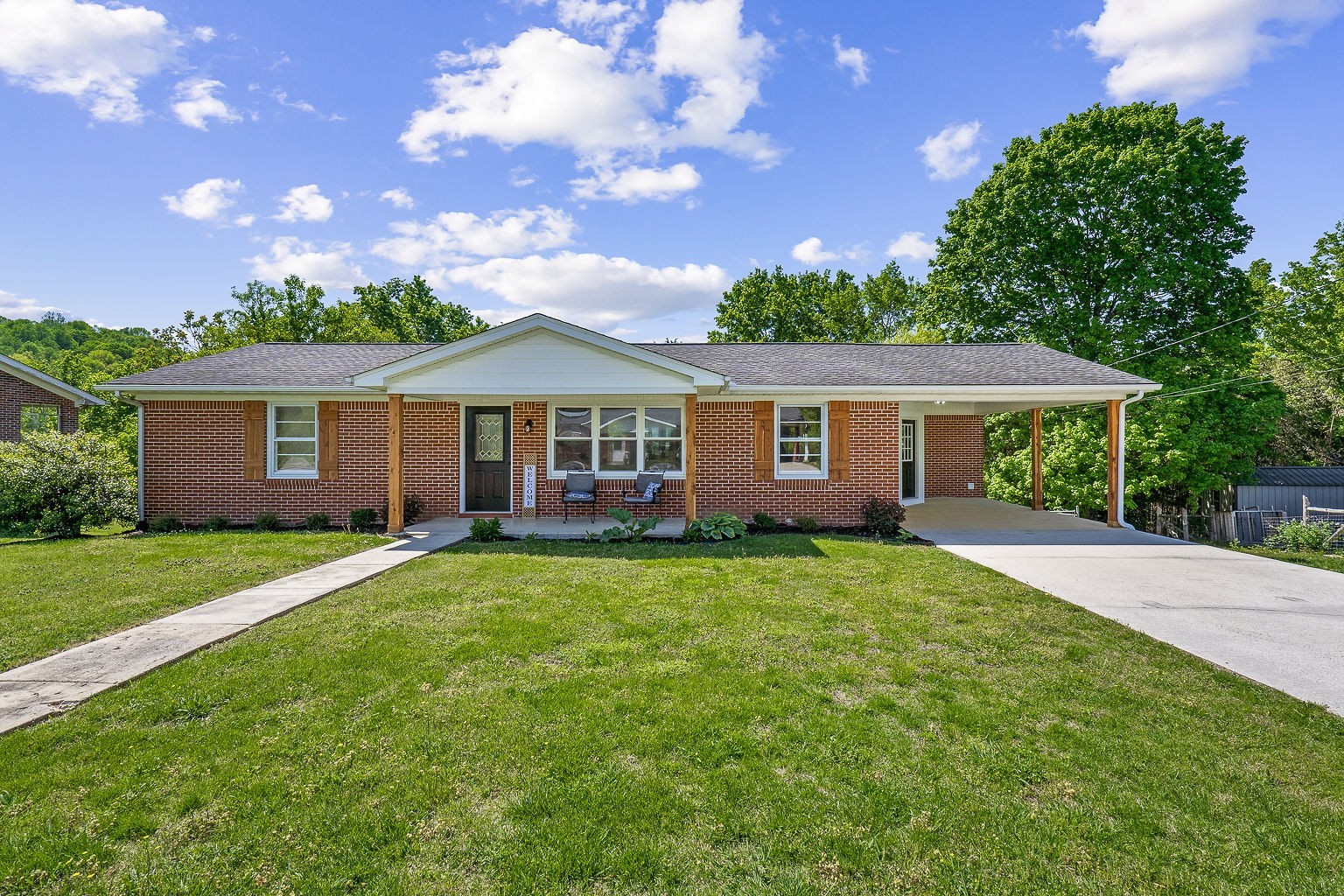 a front view of a house with a garden