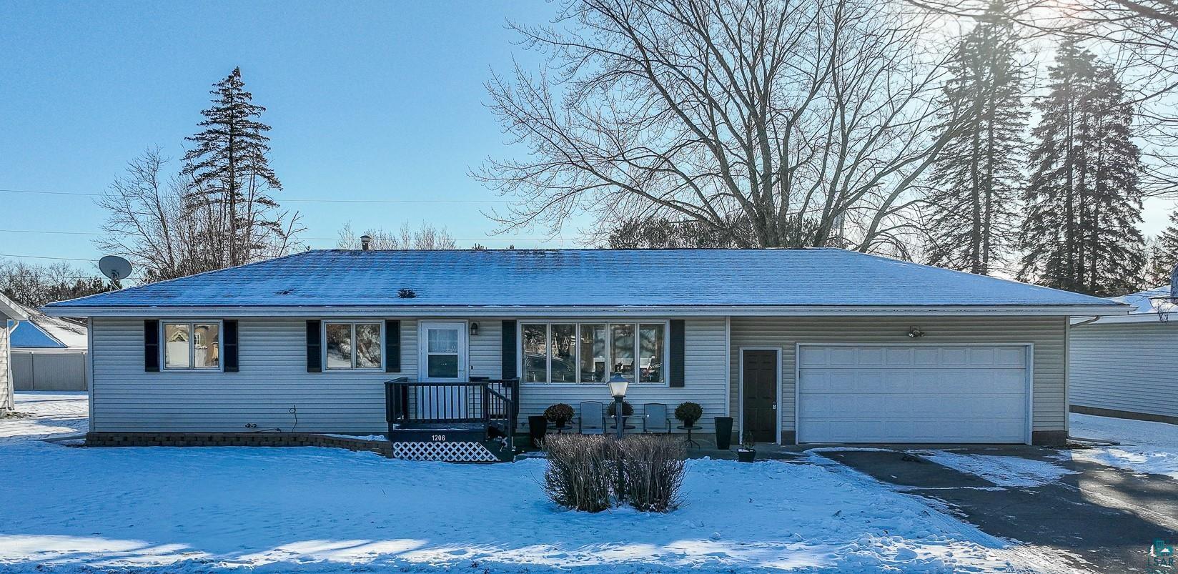 Single story home featuring a front lawn and a garage