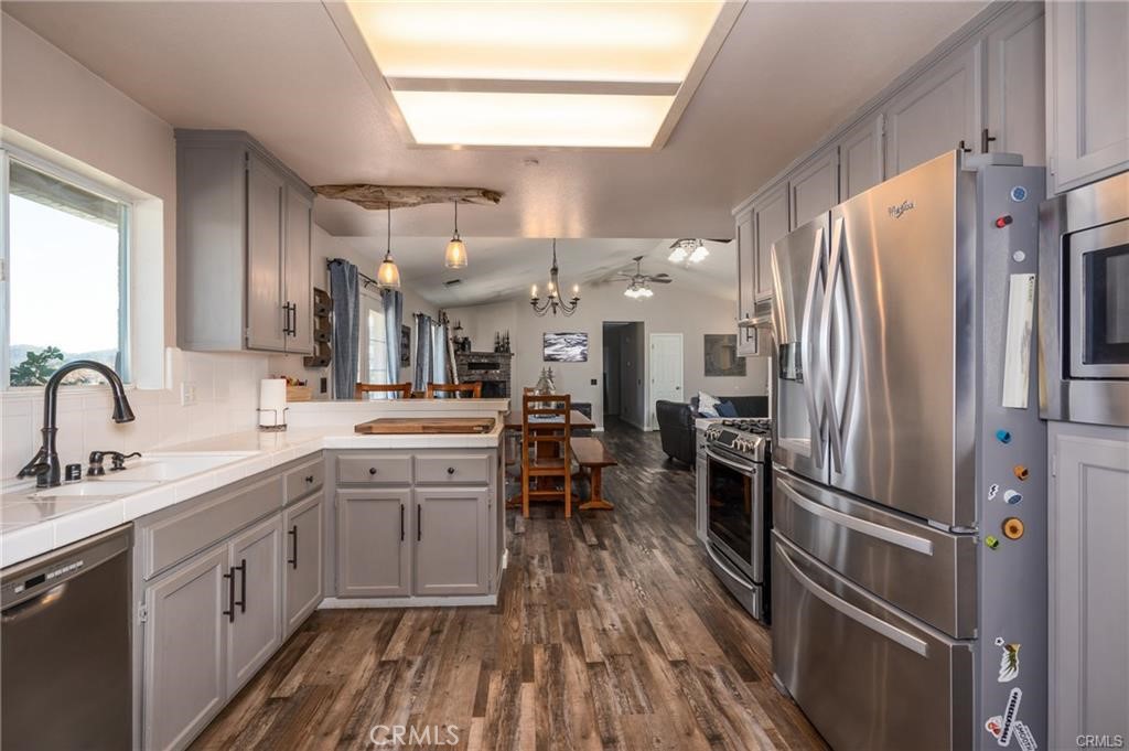 a kitchen with stainless steel appliances a refrigerator sink and cabinets