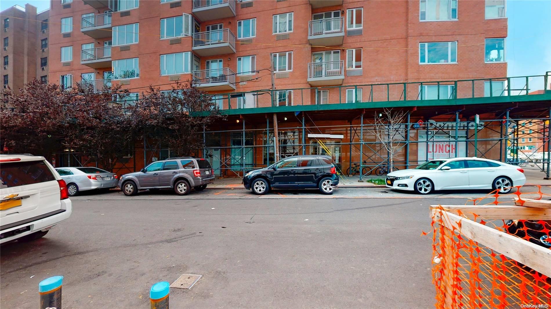 a view of a cars park in front of a building