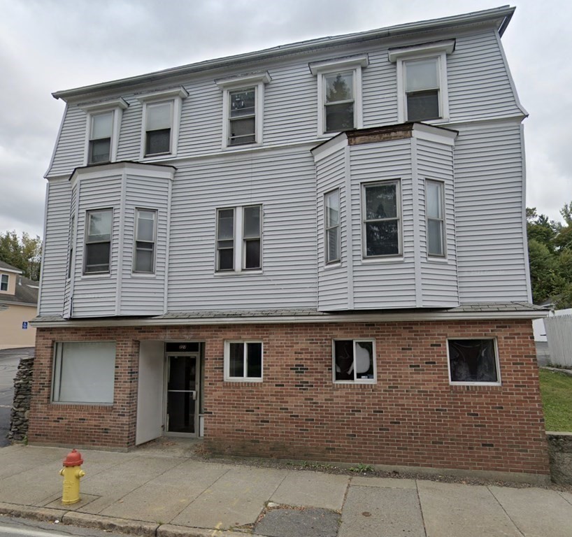 a front view of a house with a street