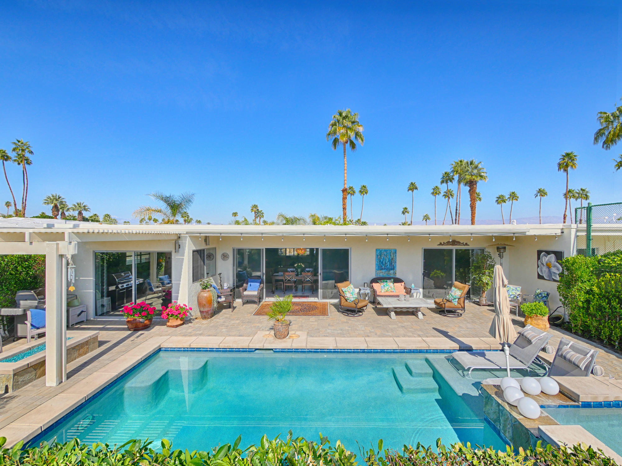 a view of swimming pool with outdoor seating