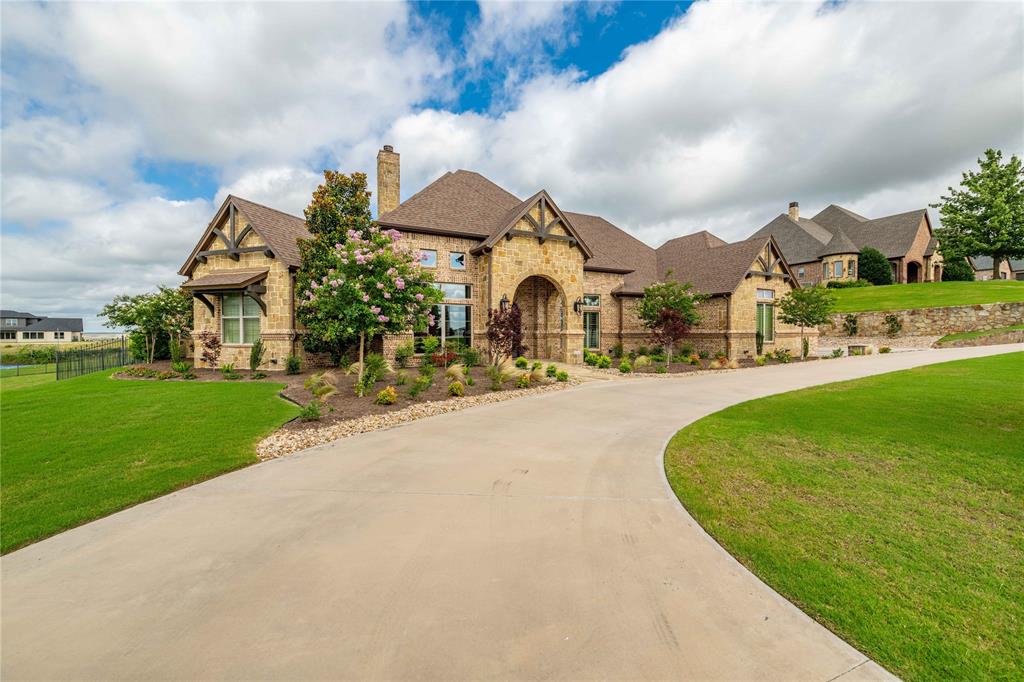 a front view of a house with a yard and fountain