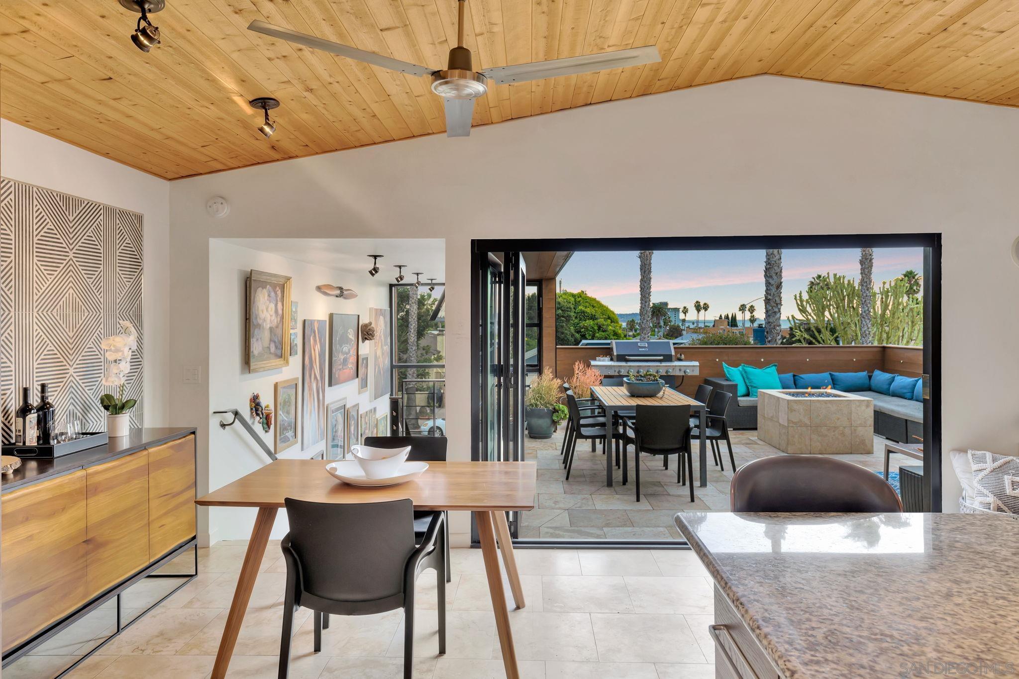 a outdoor space with lots of tables a large window and chairs