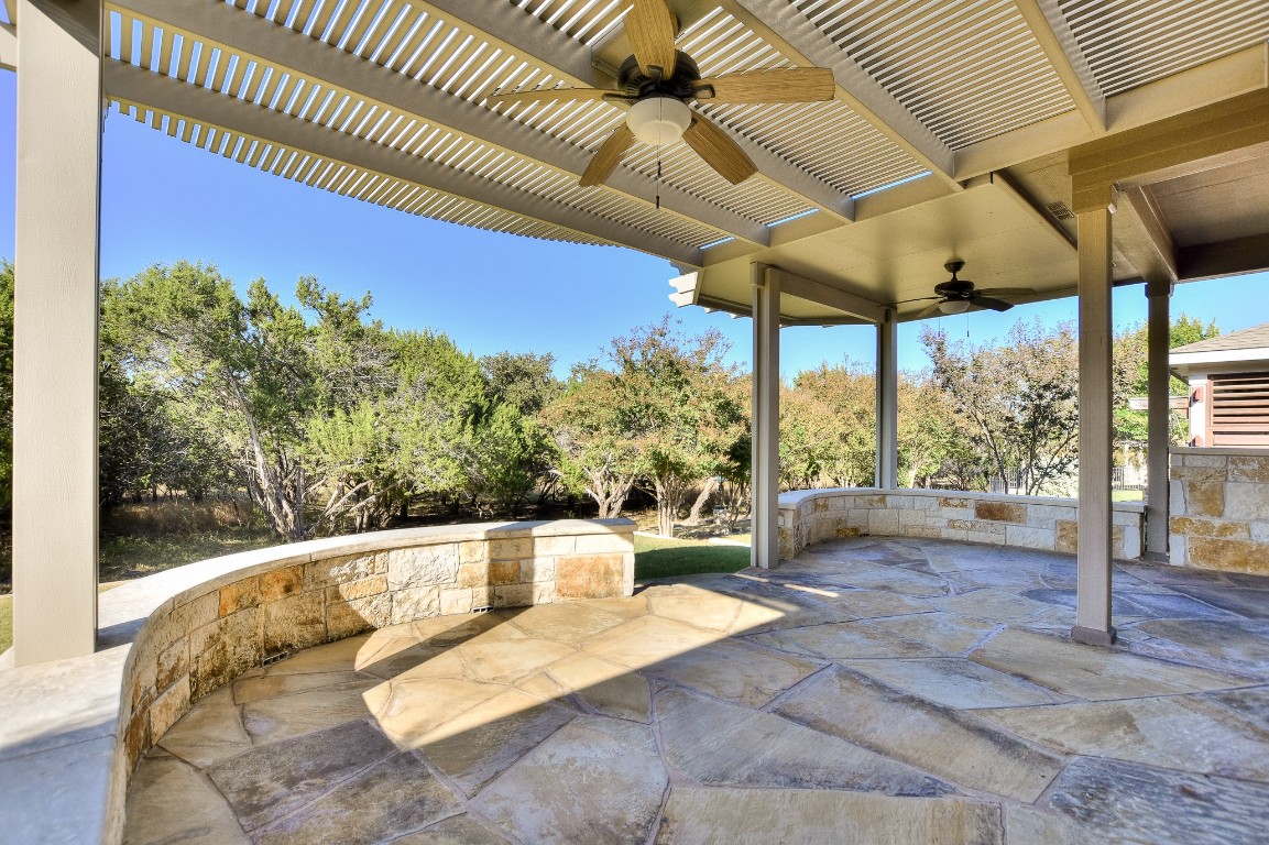 a view of a patio with a table chairs and a backyard