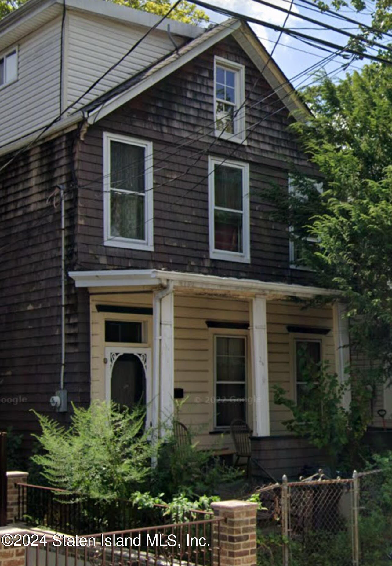 a front view of a house with plants