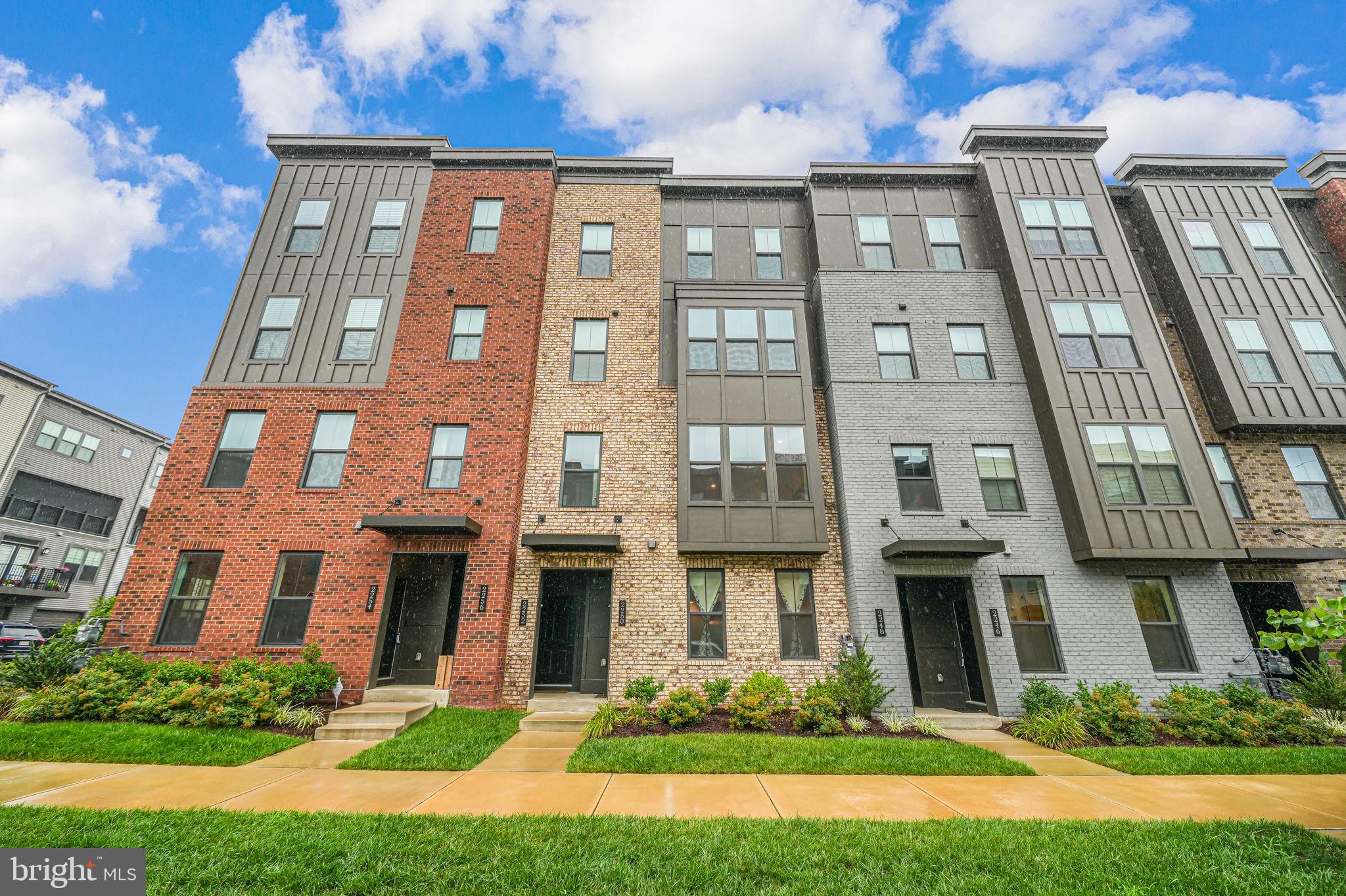 a front view of a residential apartment building with a yard