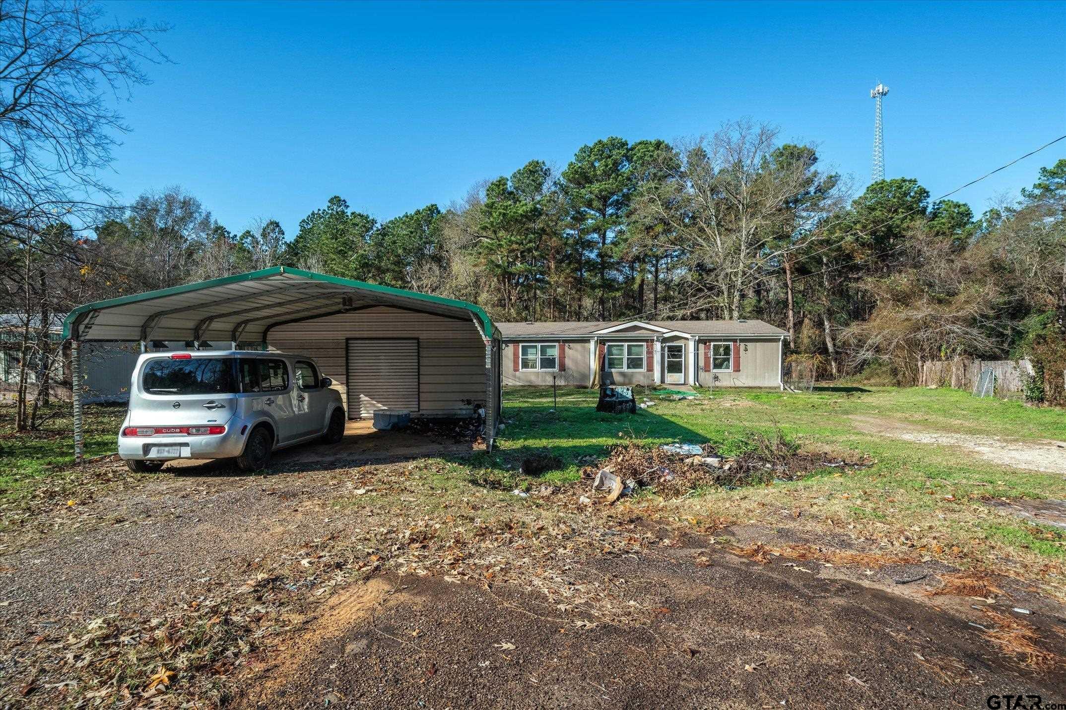 a view of a house with a car parked in it