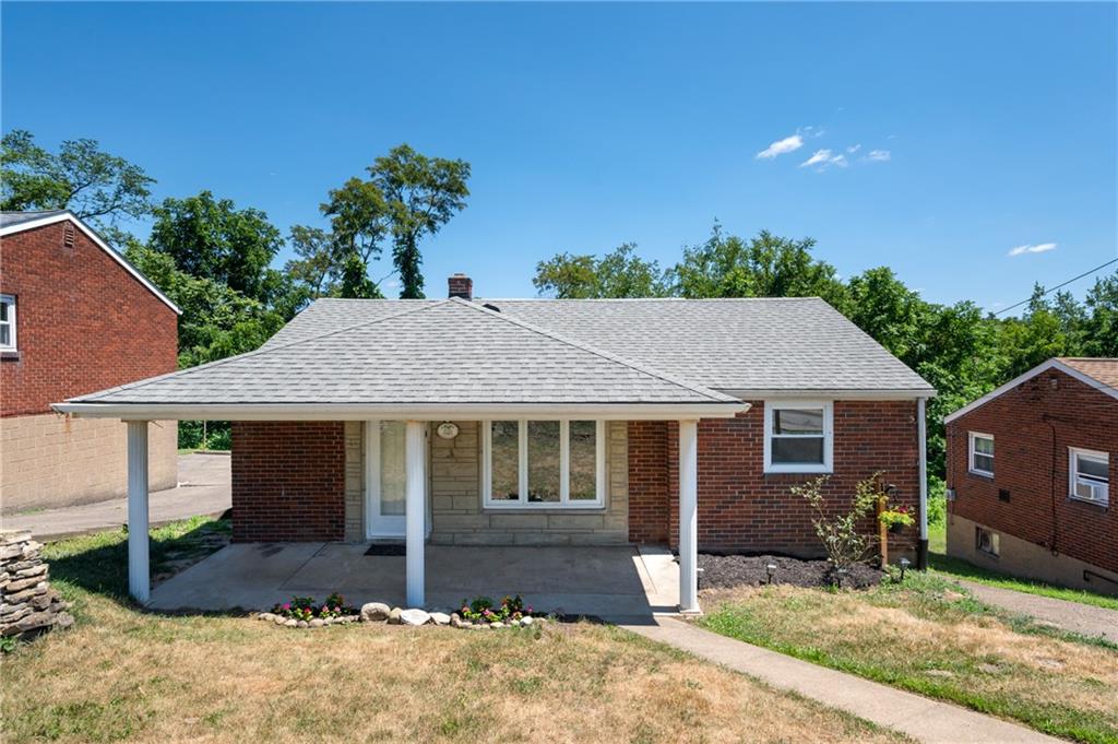 a house that has a tree in front of it