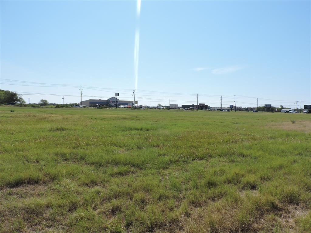 a view of a field with an ocean view