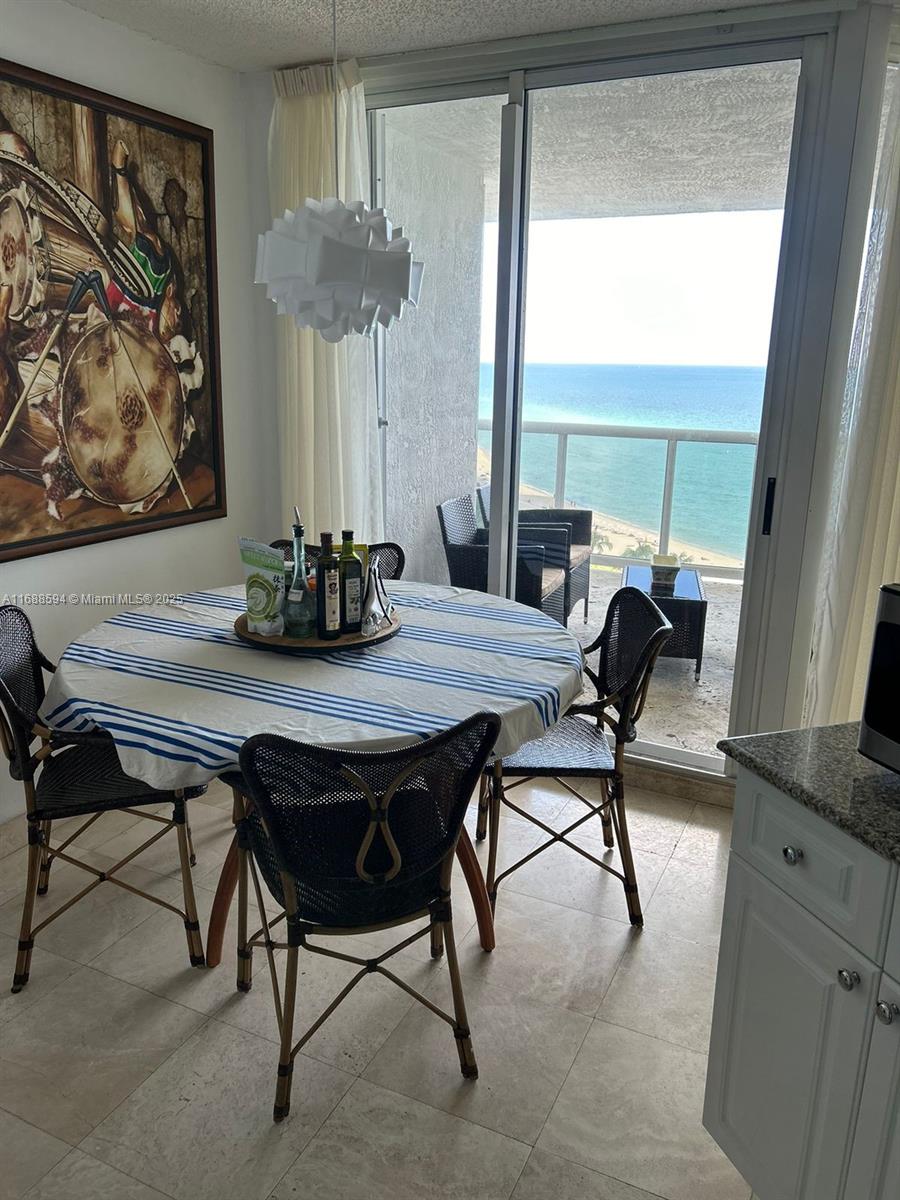 a view of a dining room with furniture window and outside view