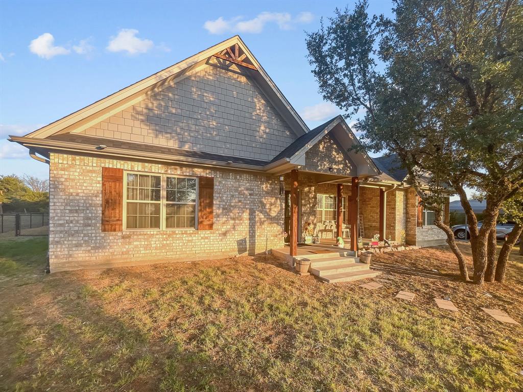 a front view of a house with a yard and outdoor space