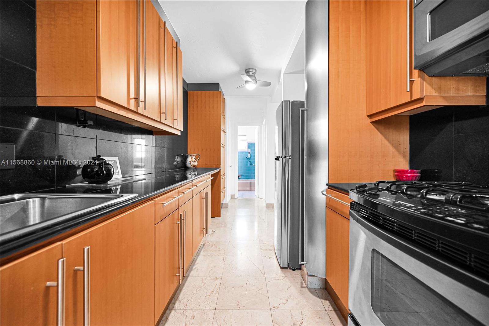 a kitchen with stainless steel appliances granite countertop a stove and a refrigerator