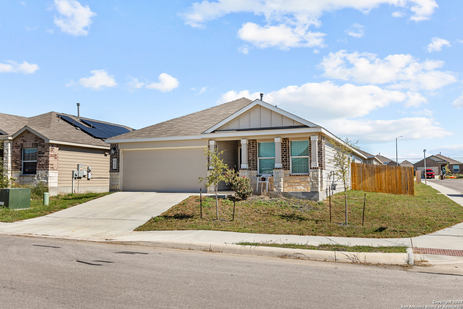 a front view of a house with garden