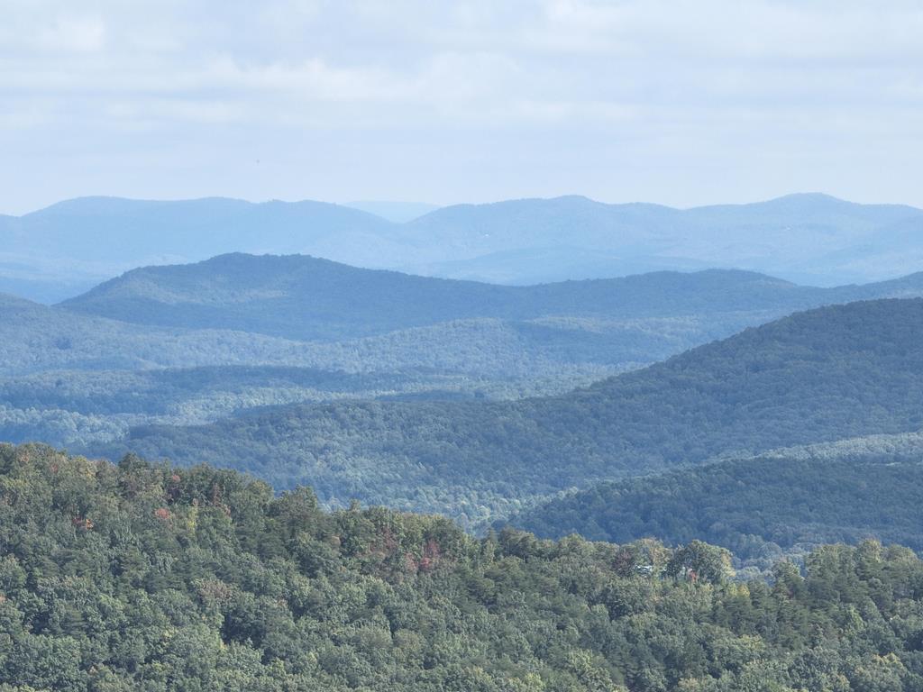 a view of a mountain range with trees in the background