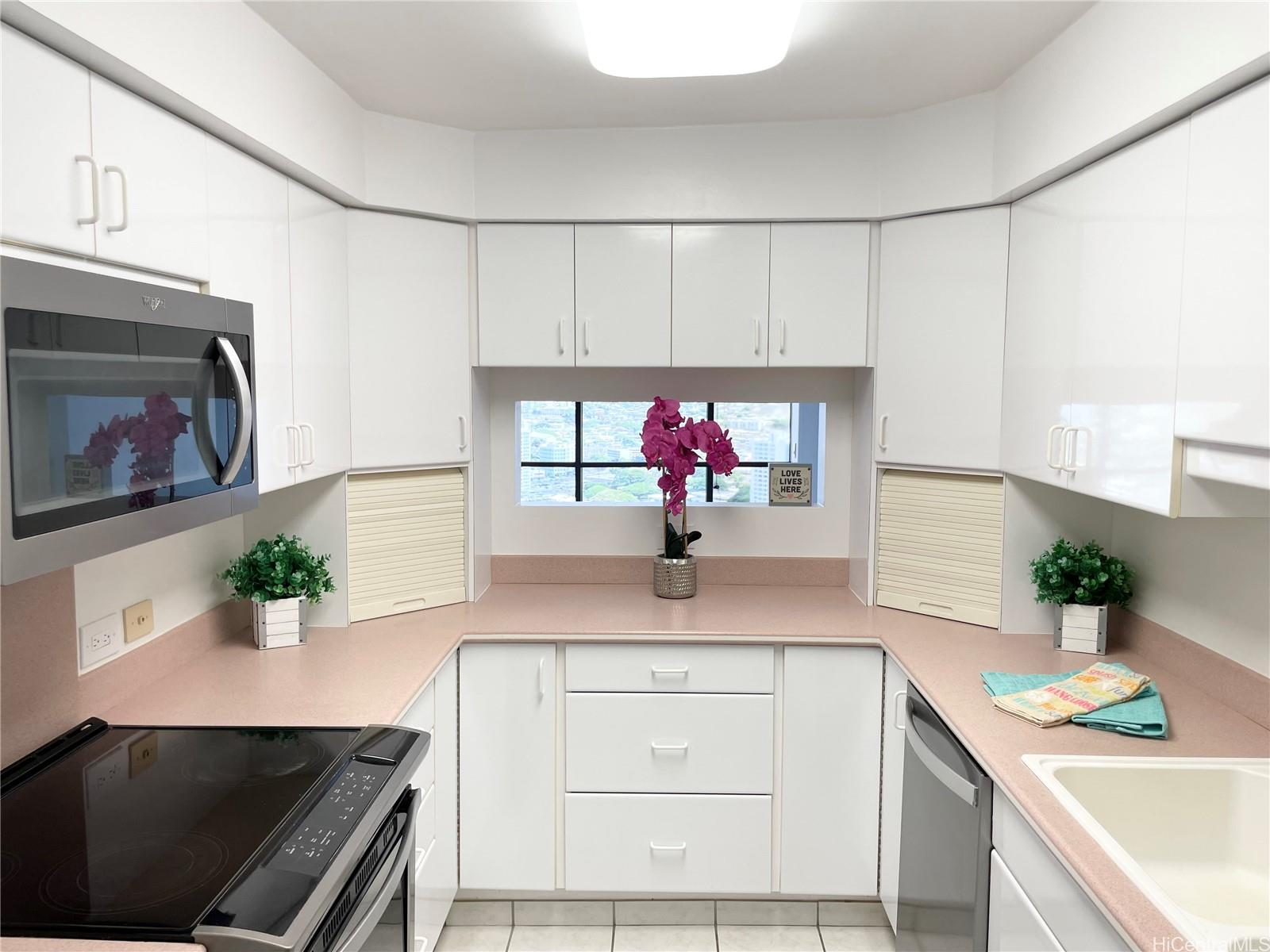 a kitchen with stainless steel appliances white cabinets and a counter top space