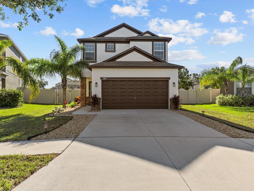 a front view of a house with a yard and garage