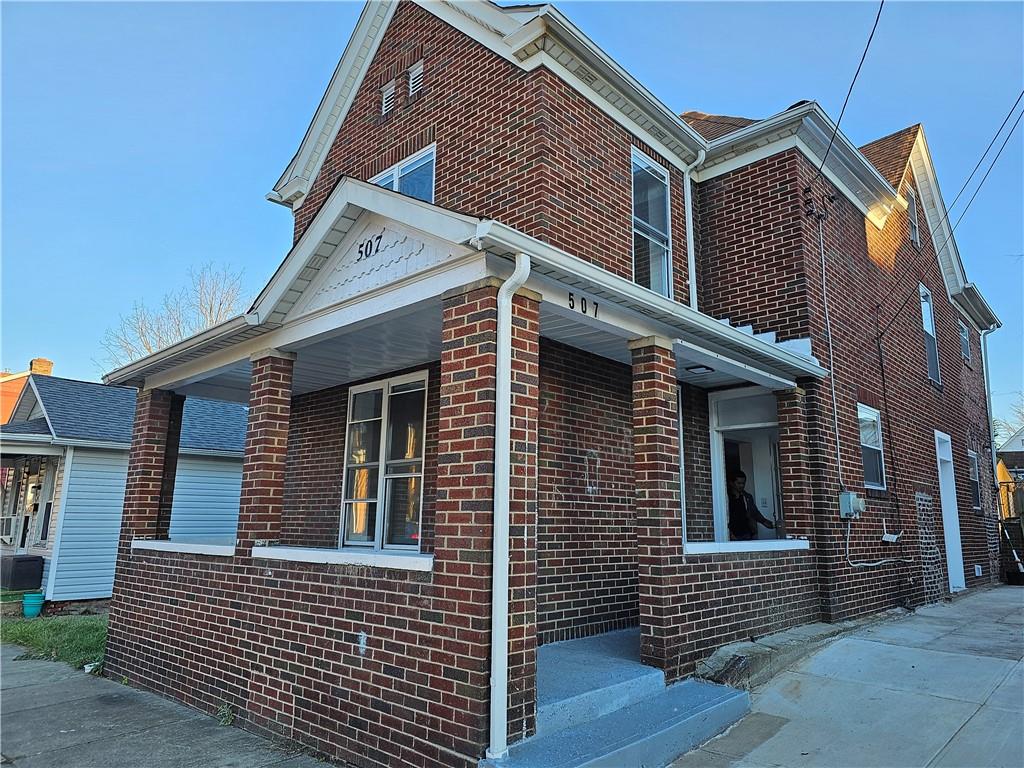 a view of a house with brick walls