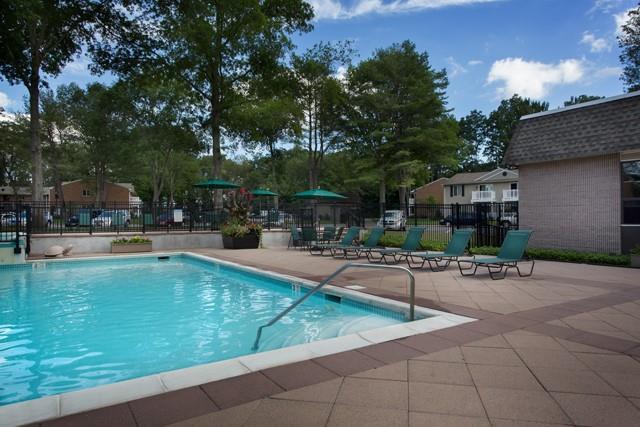 a swimming pool with outdoor seating and yard