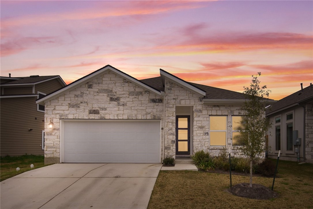 a front view of a house with garage