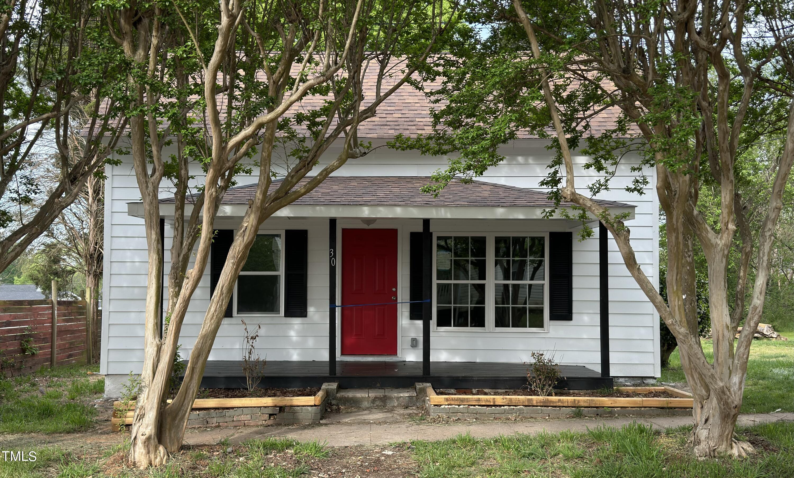 front view of a house with a tree