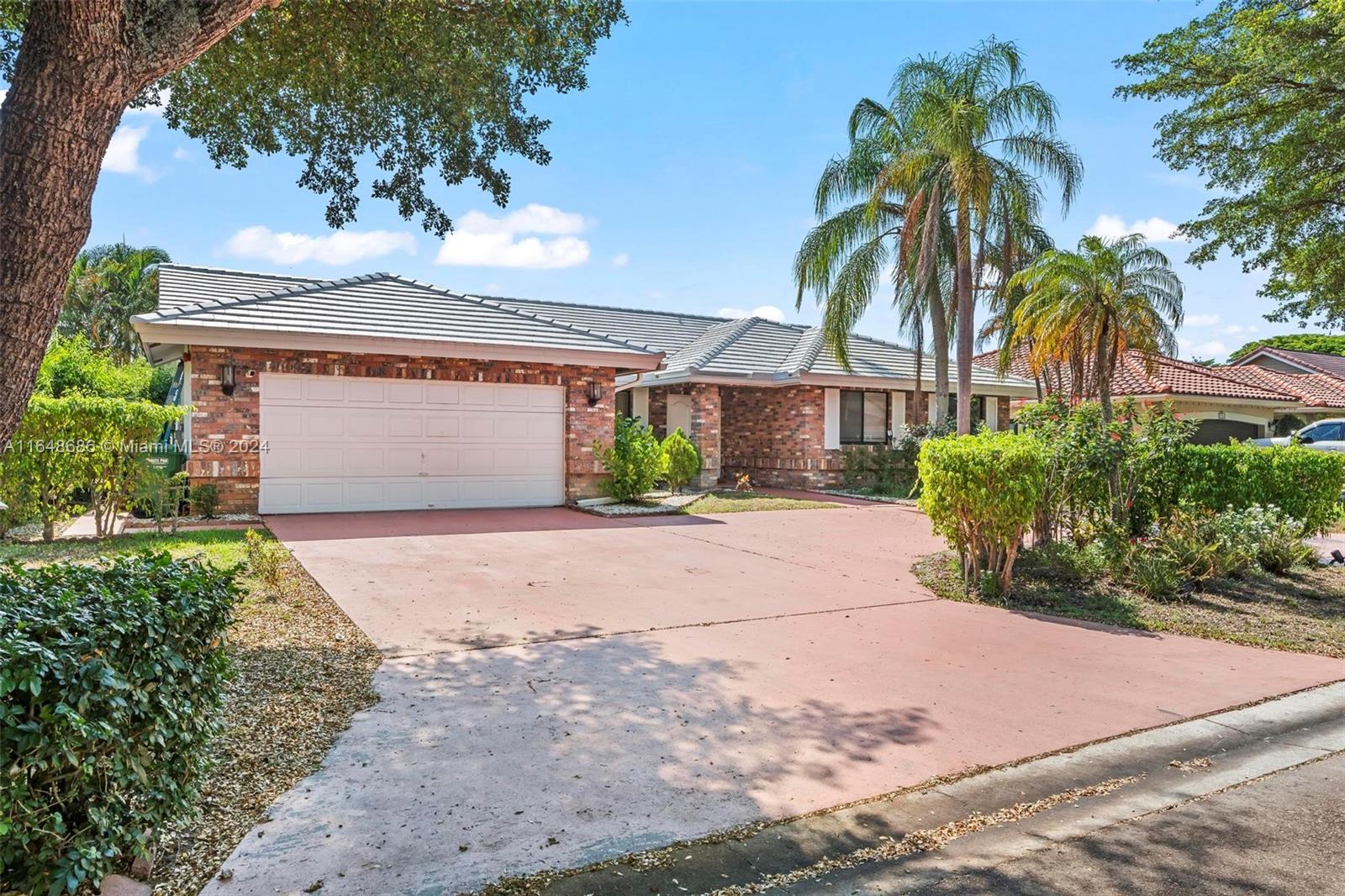 a front view of a house with a yard and a garage