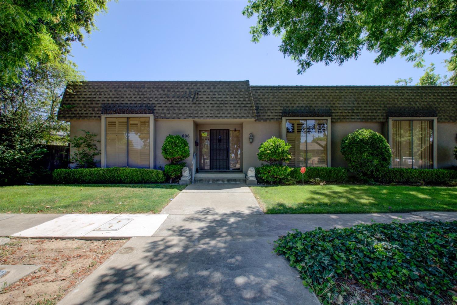 a front view of a house with a garden