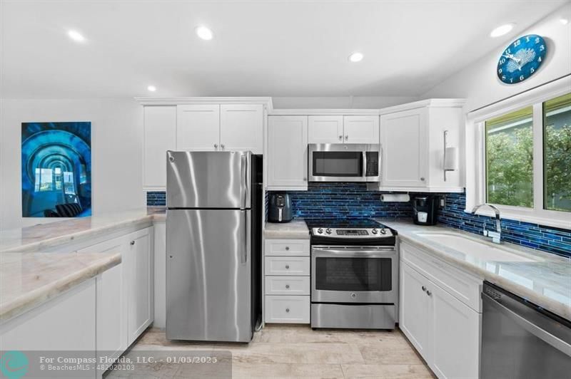 a kitchen with a refrigerator stove and sink