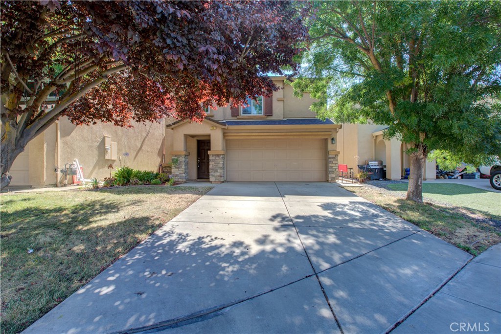 a front view of a house with a yard and garage