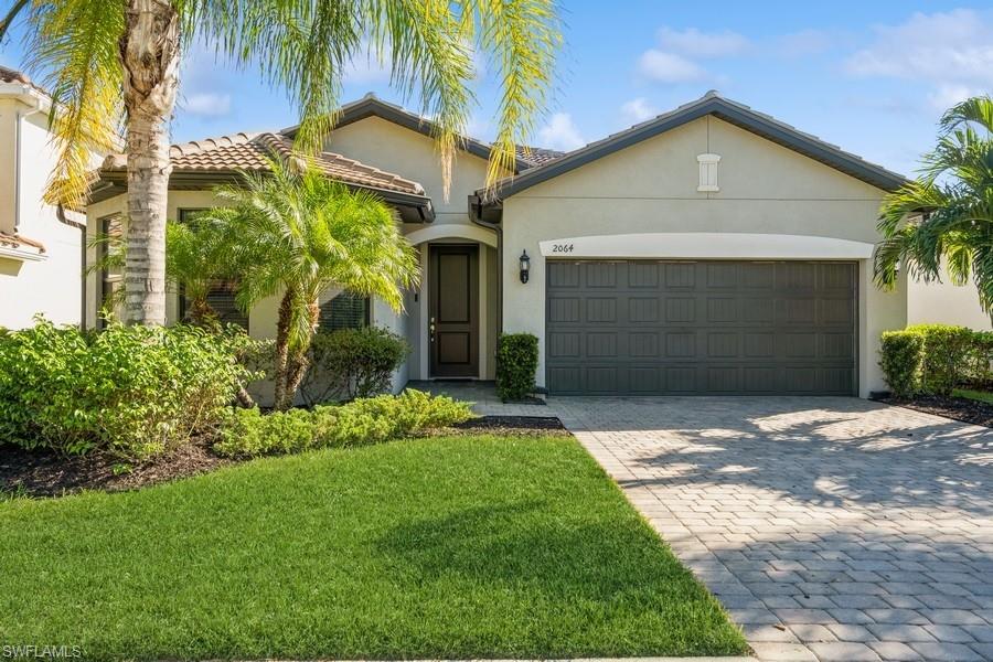 View of front of home featuring a garage and a front yard