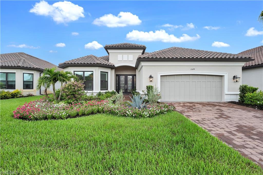 a front view of a house with a garden and plants