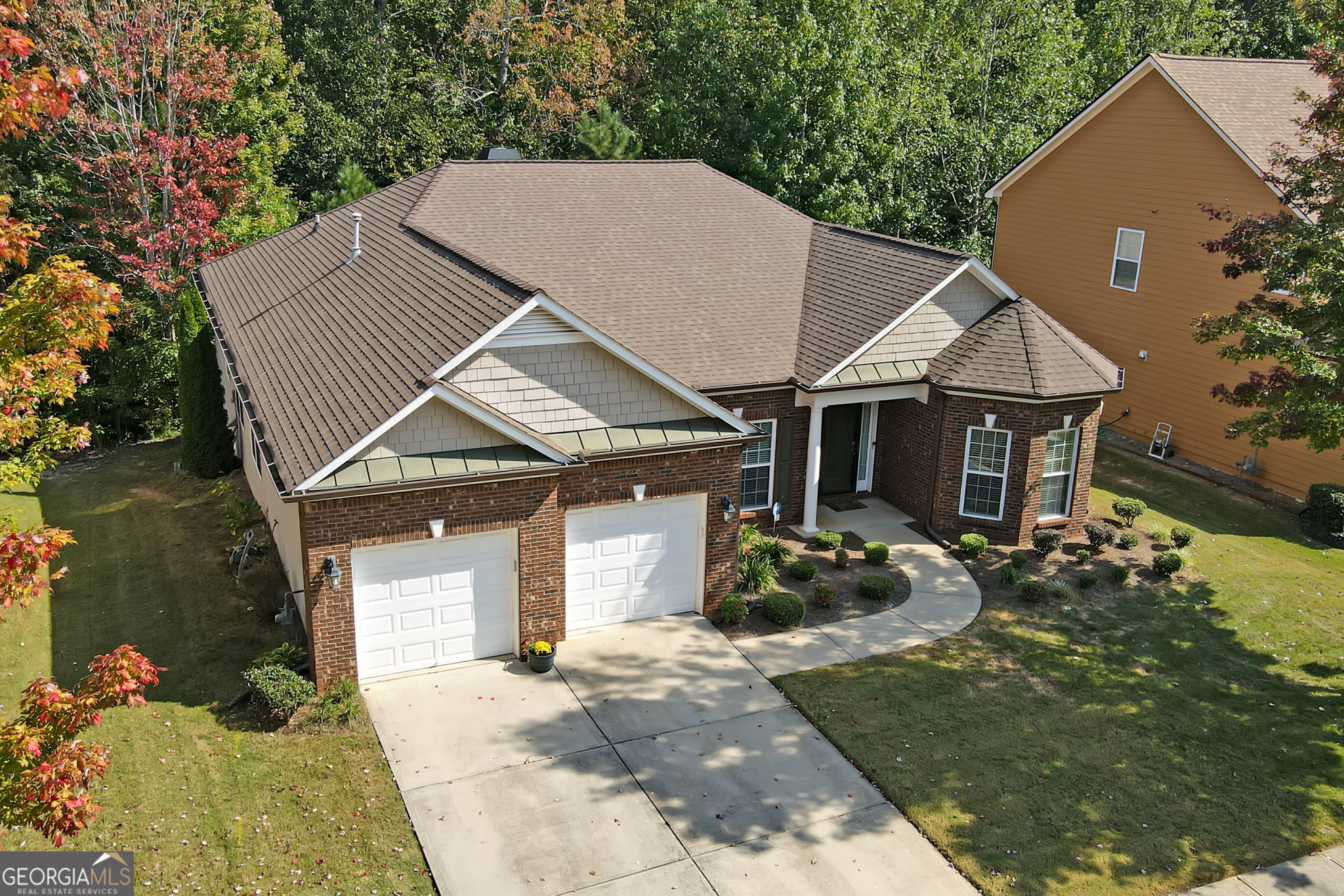 a front view of a house with a garden and yard