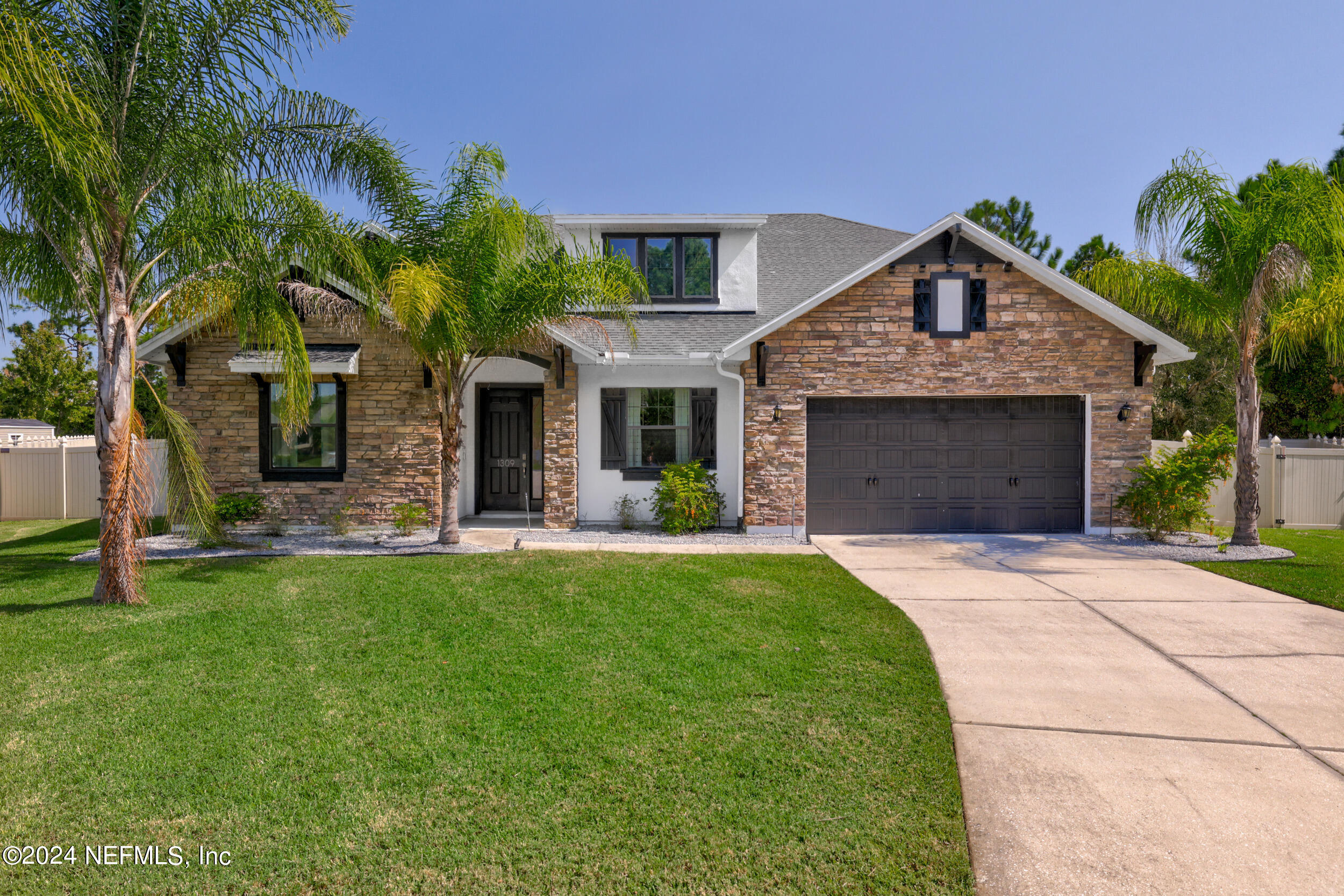 a front view of a house with a garden and plants