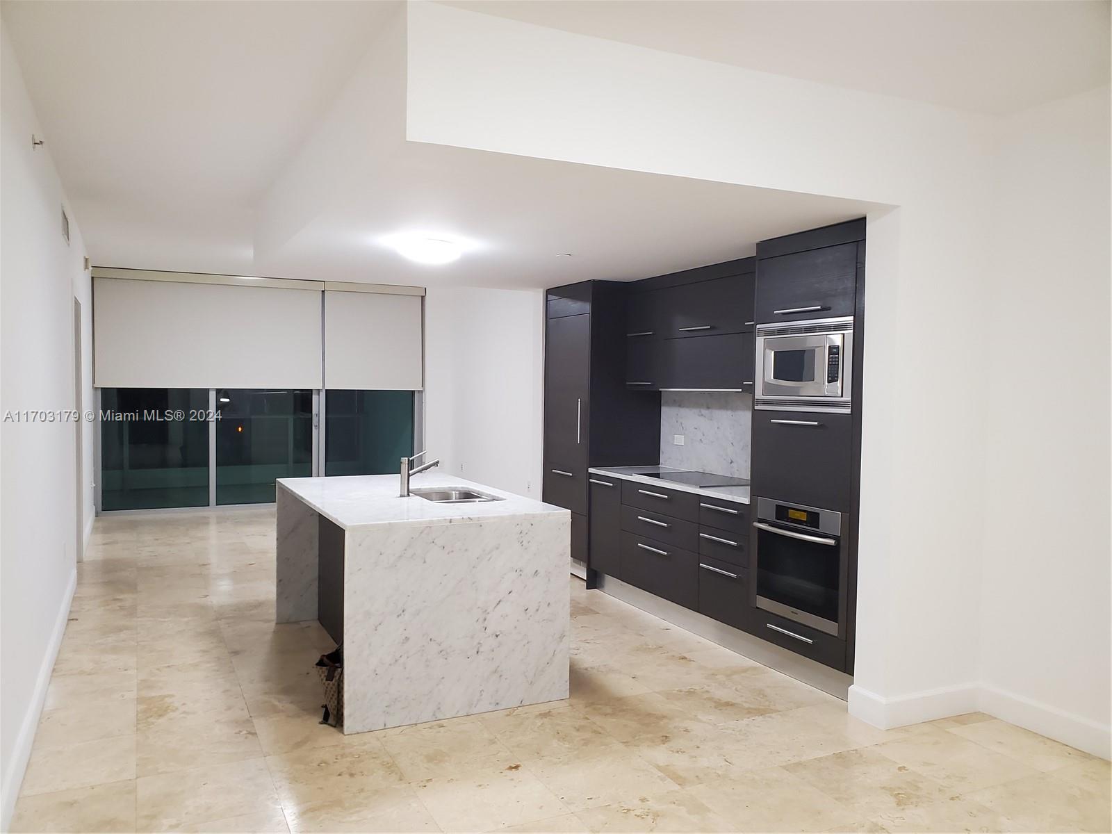 a kitchen with kitchen island cabinets and stainless steel appliances