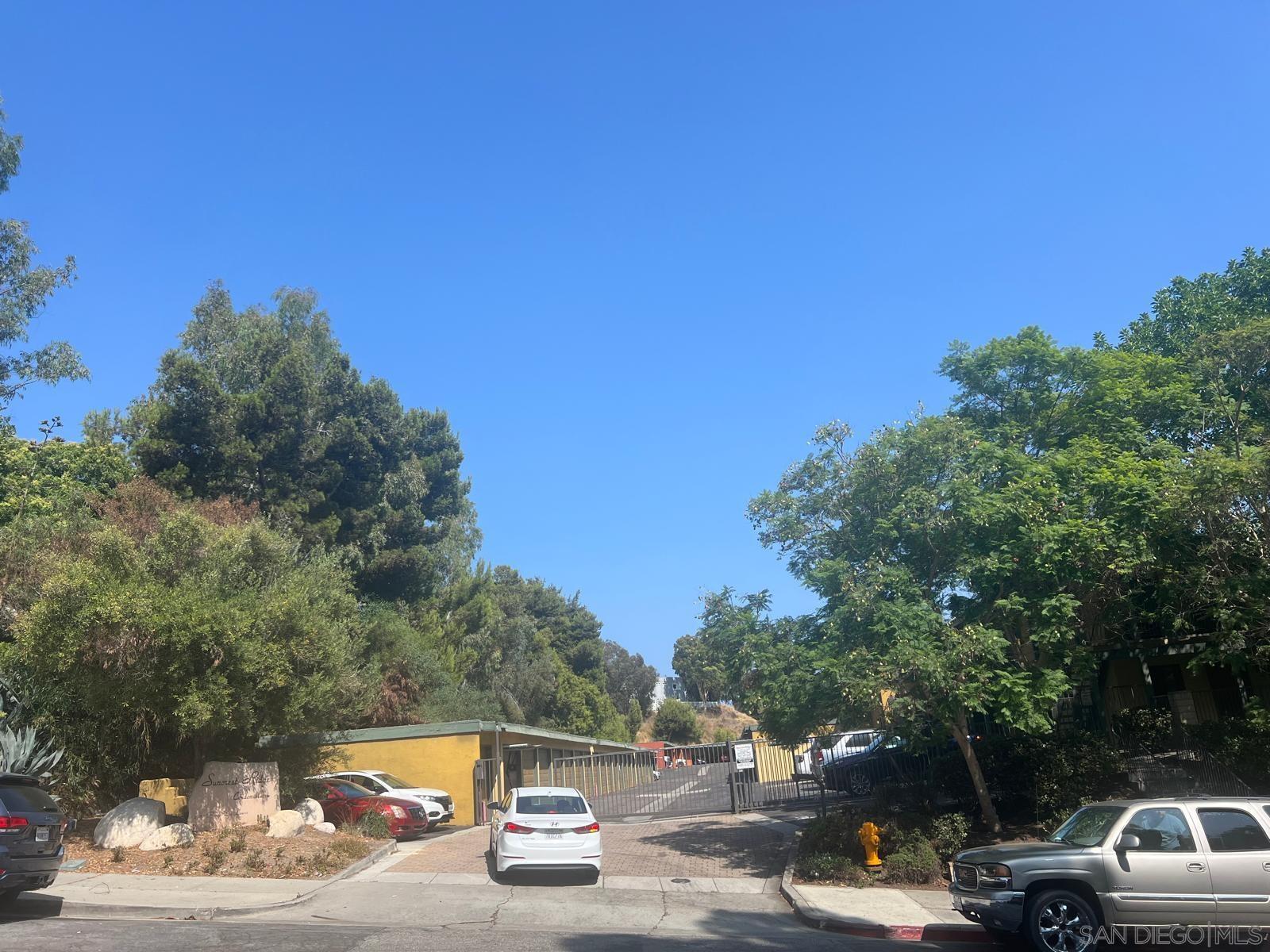 a view of a city street with a car parked on the road