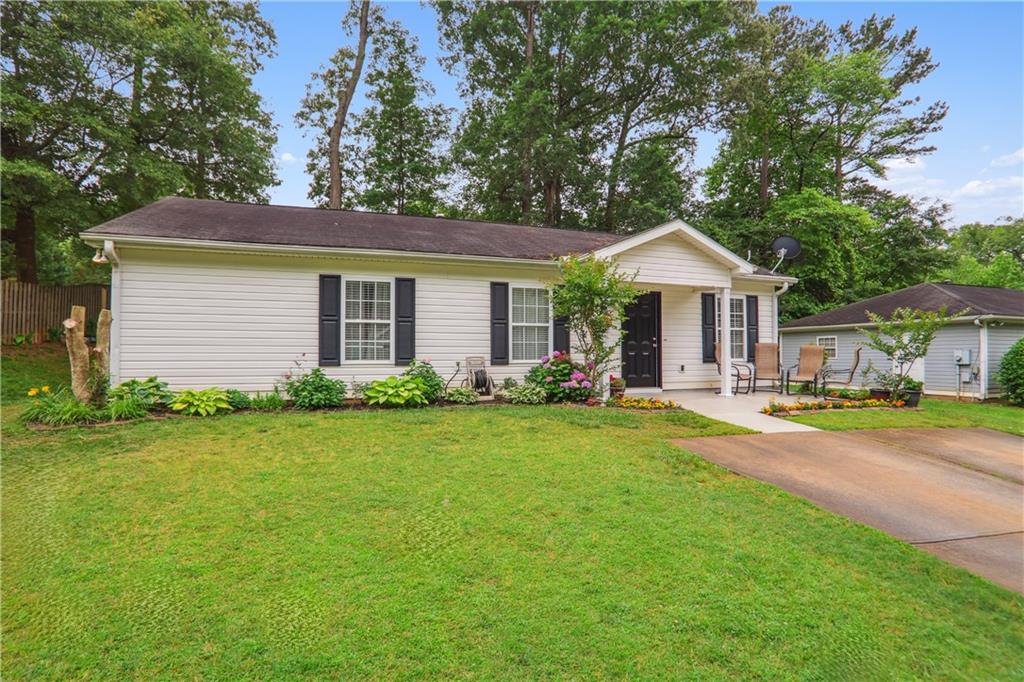 a front view of a house with yard and green space