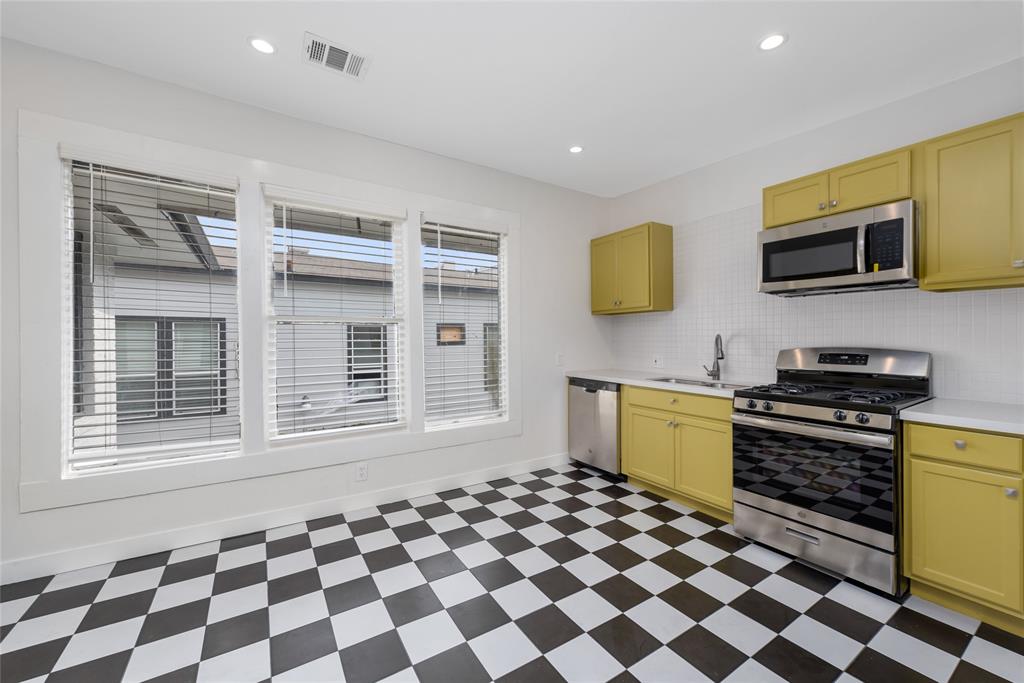 a kitchen with a stove a sink and a microwave