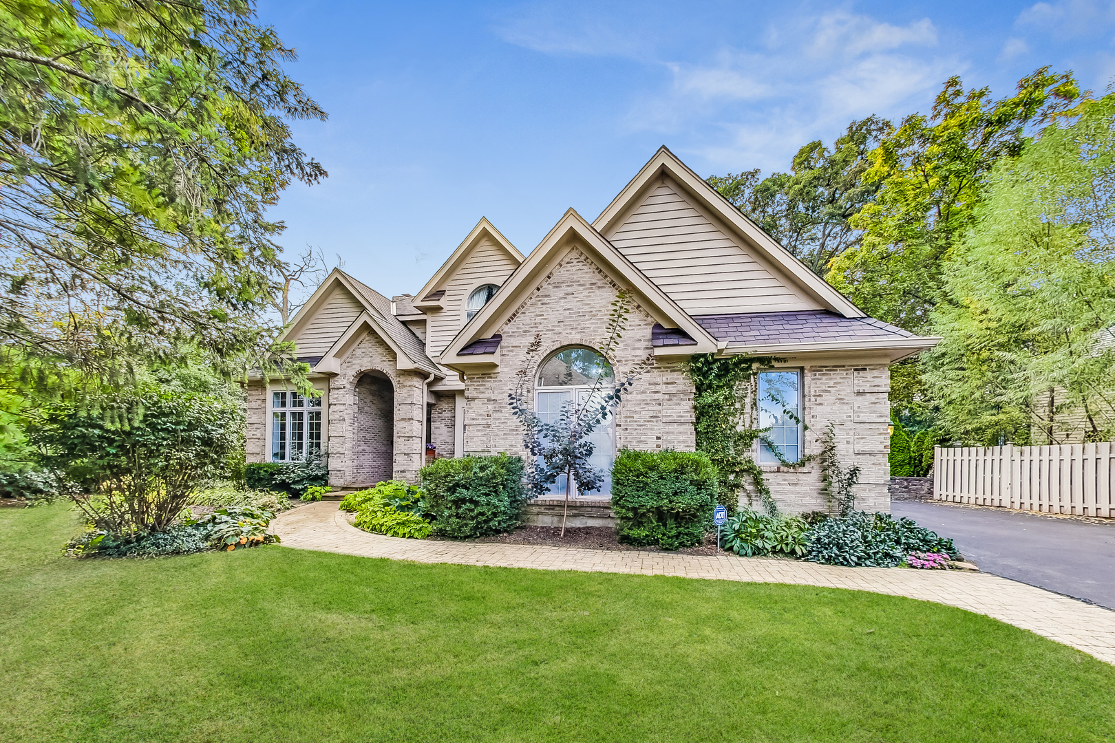 a front view of a house with a garden