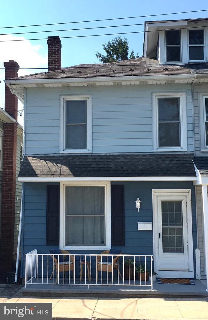 a view of a house that has a small deck