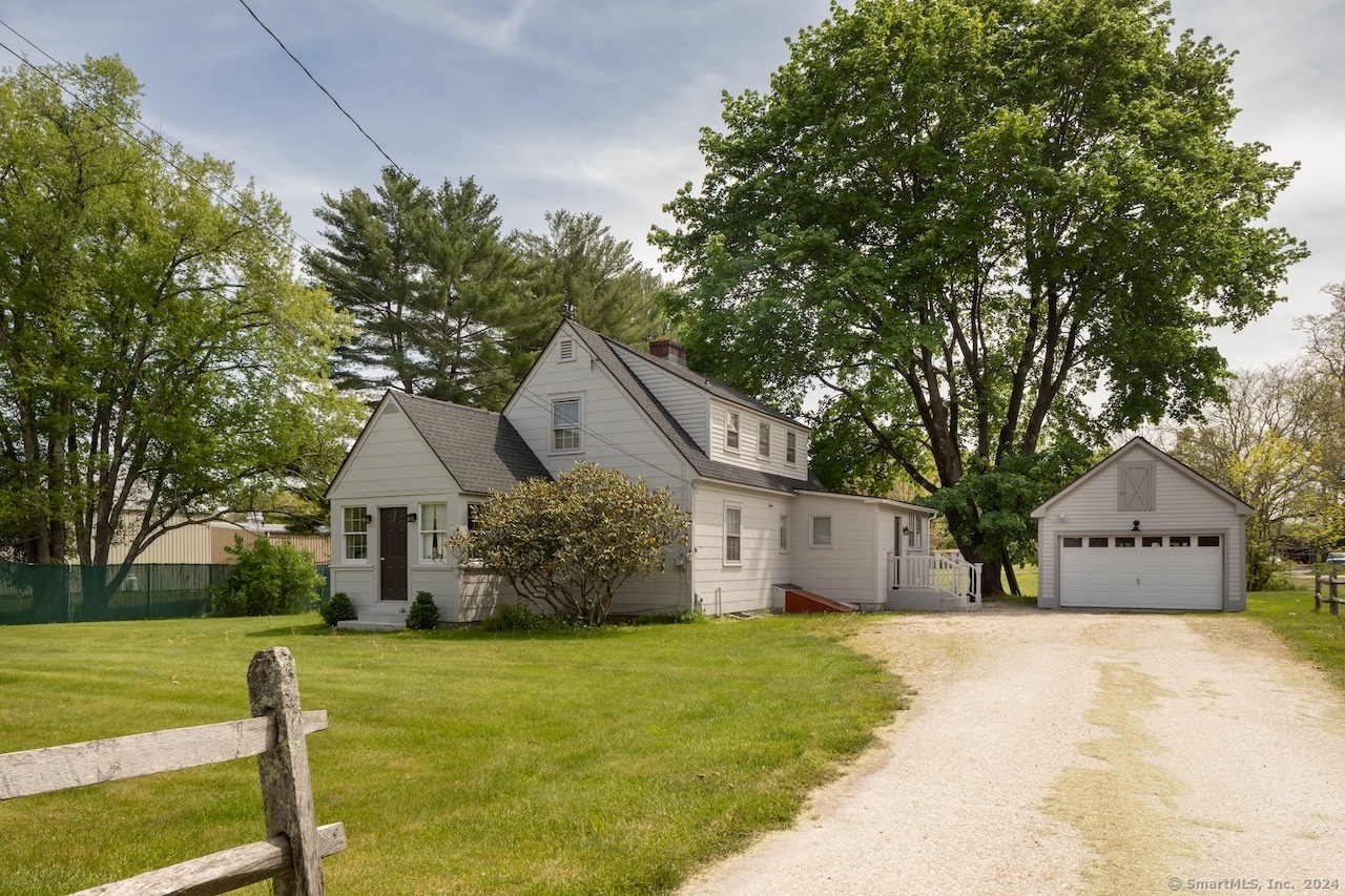 a front view of house with yard and green space