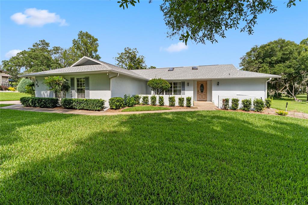 a front view of a house with a garden