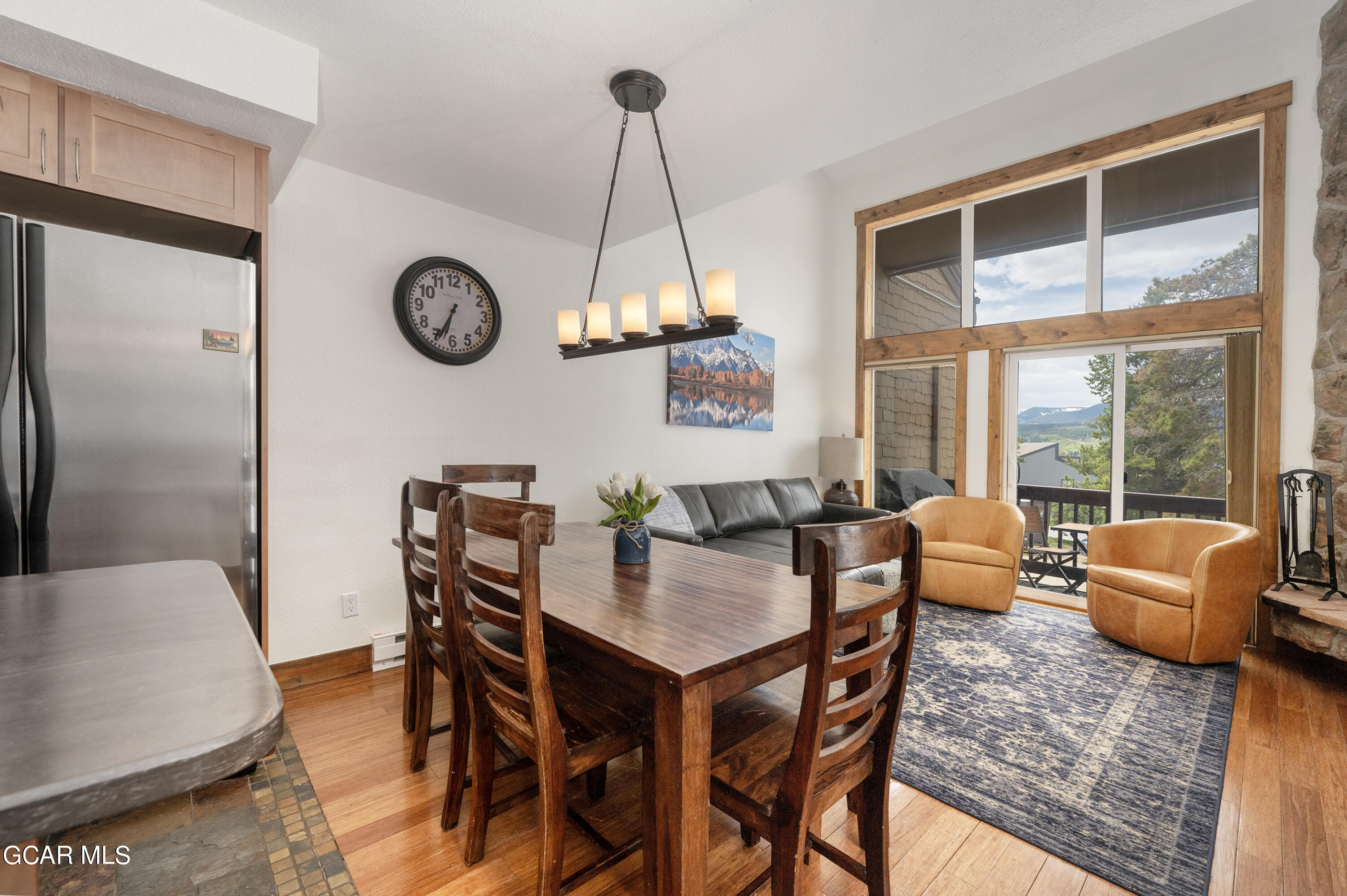 a dining room with furniture a chandelier and a rug