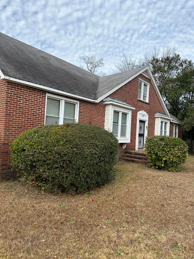 front view of a house with a yard