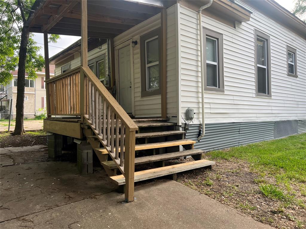 a backyard of a house with wooden floor and fence