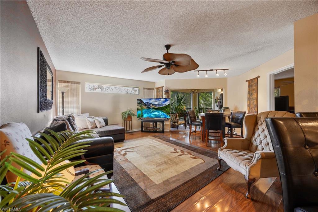 a living room with lots of furniture and a large window