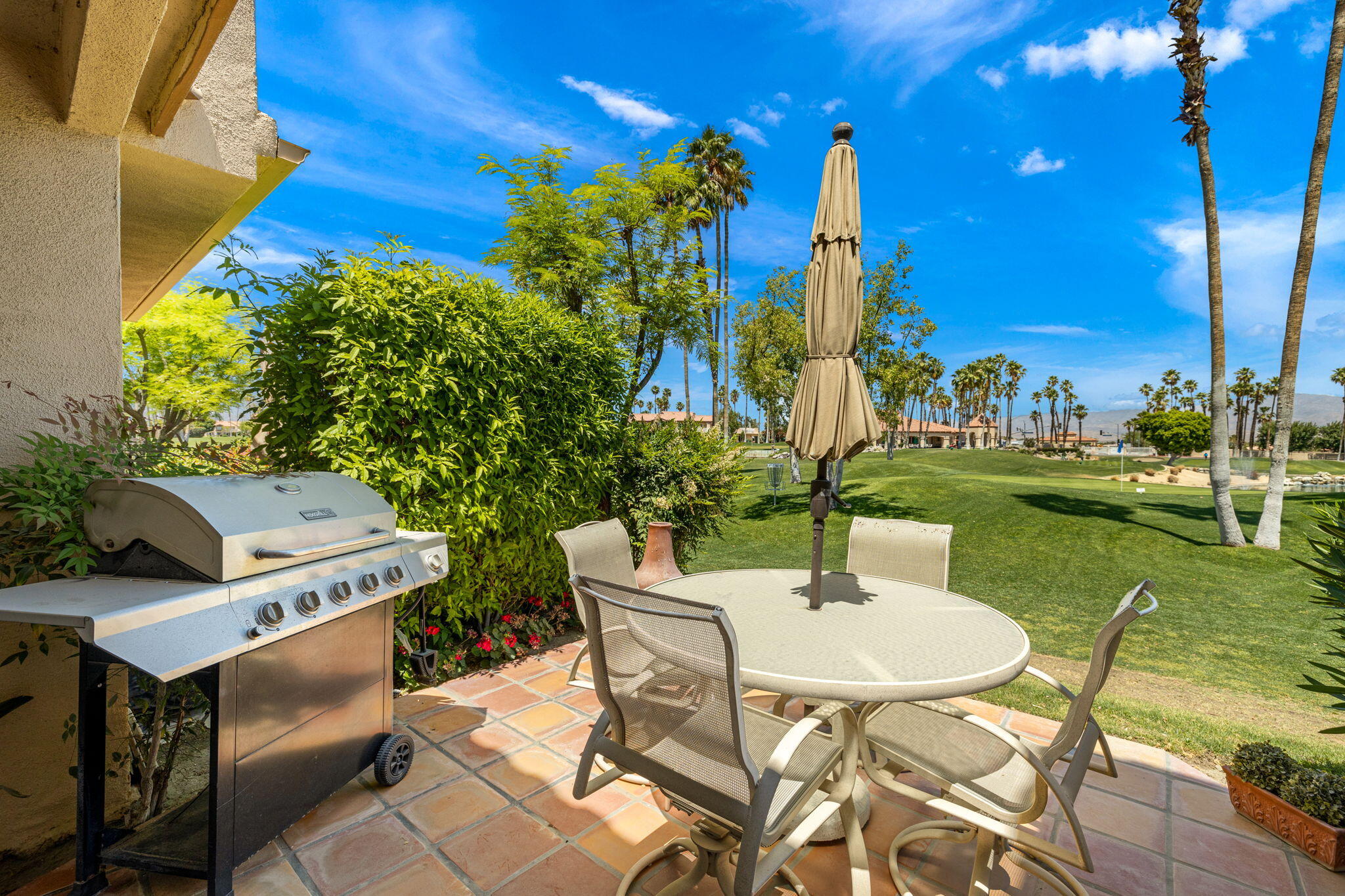 a backyard of a house with table and chairs