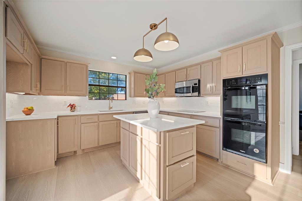 a kitchen with a sink stove and refrigerator