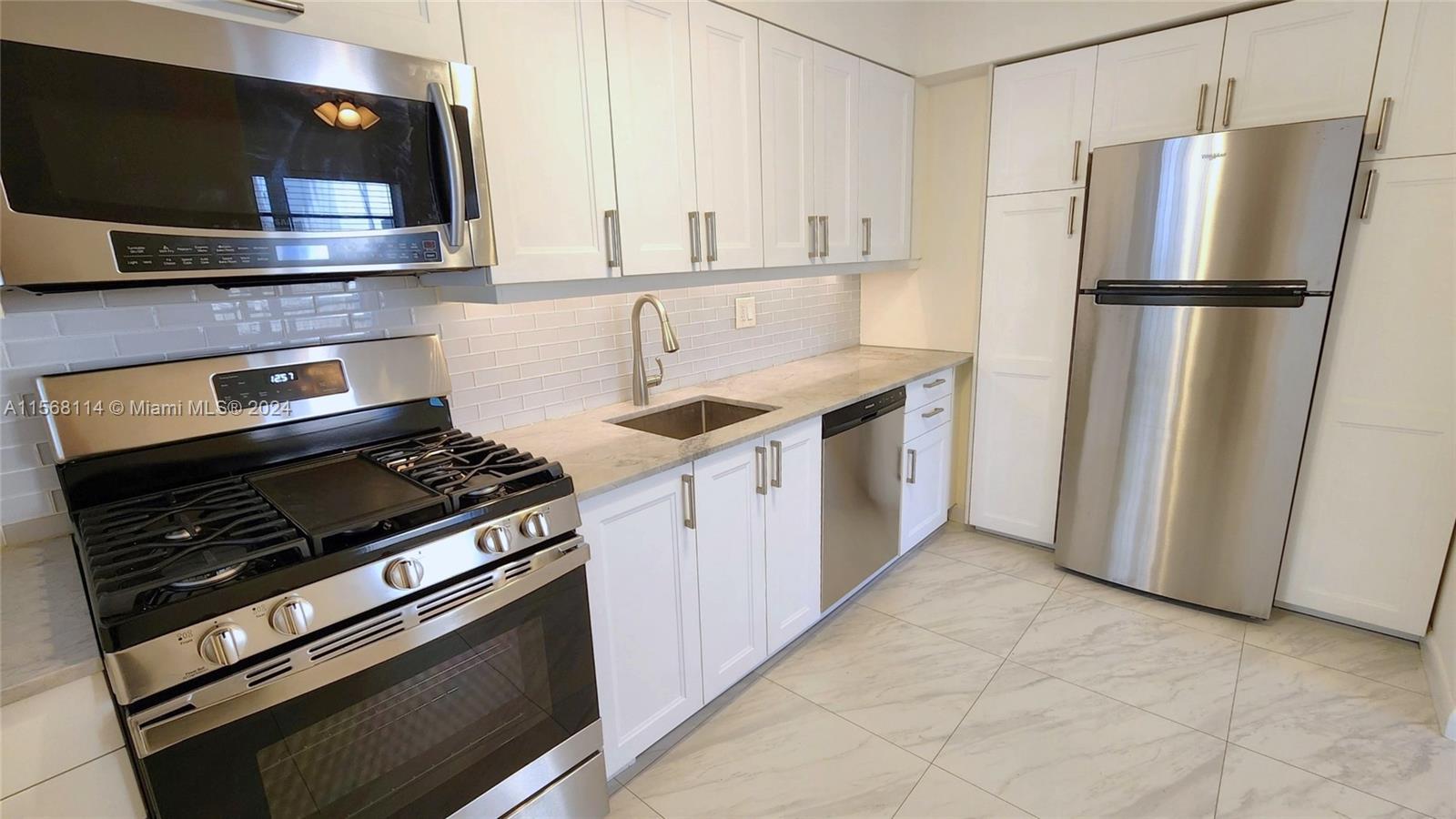 a kitchen with appliances and cabinets