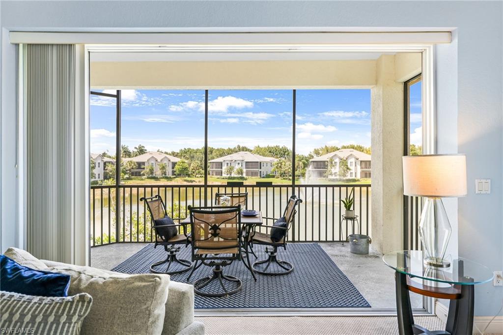 a living room with furniture and a floor to ceiling window