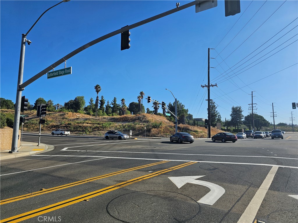 a view of a city street with a cars parked